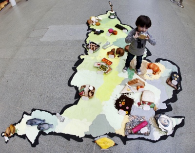 EDITORIAL USE ONLY
Tomas Quinn aged 3 from London stands on VisitEngland?s edible map, in London?s St Pancras station, which is made from cakes representing the country?s food festivals, to mark British Food Fortnight, which runs from September 21st to Oc