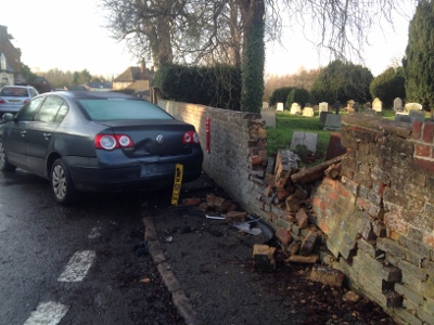 The damaged churchyard wall at Sydenham after it was hit twice by passing cars