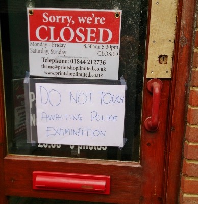 The damaged door of the Print Shop, Swan Walk, awaiting examination by the police